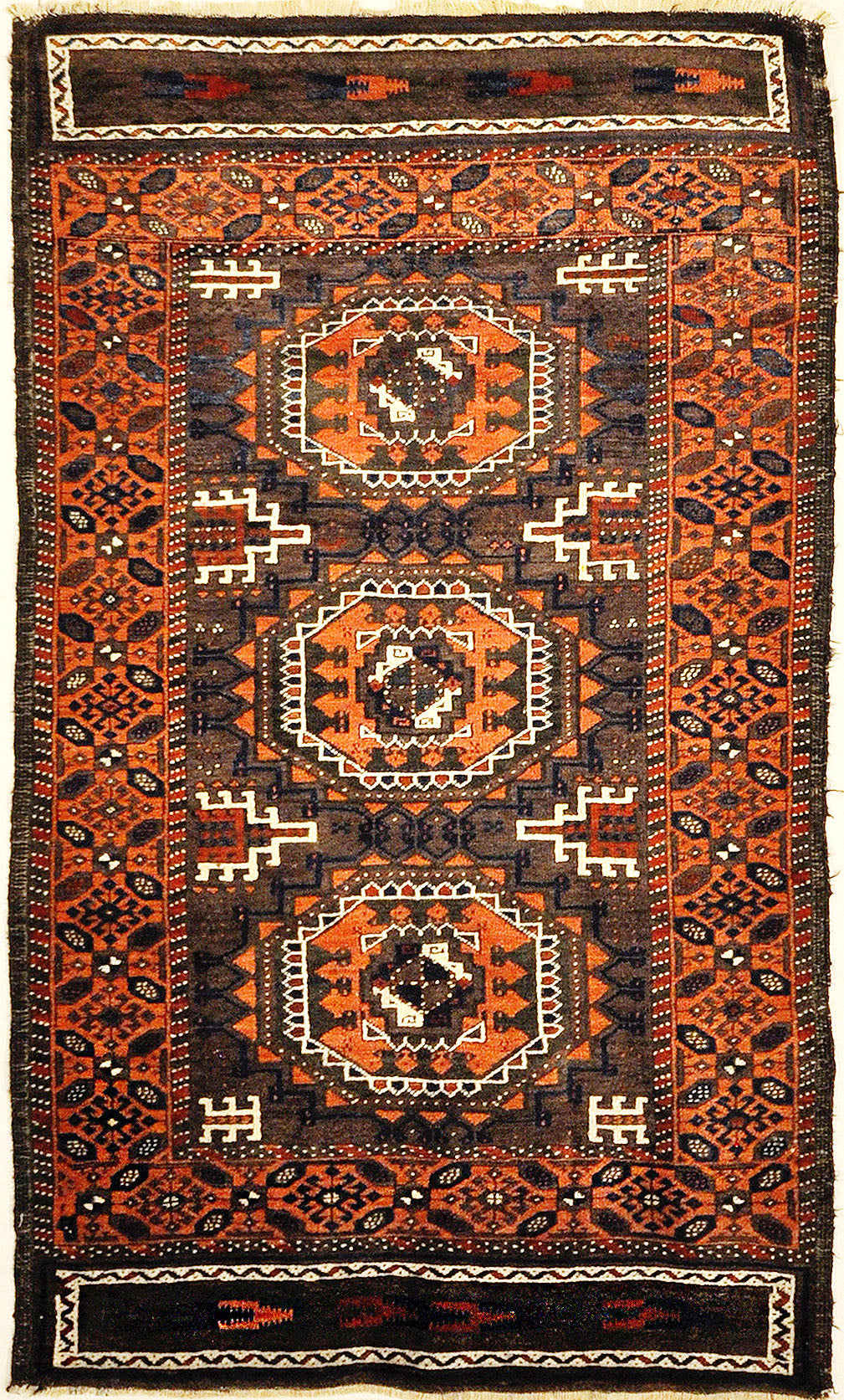 Antique Original Baluch with 3 Medallions and Unique Knotted Ends. An Afghan piece of original genuine woven carpet art sold by Santa Barbara Design Center.
