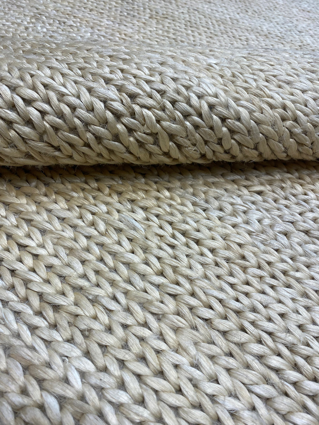 Close-up view of the texture and weave of Ziegler & Co. Modern Rug in light beige, showcasing its intricate braid pattern.