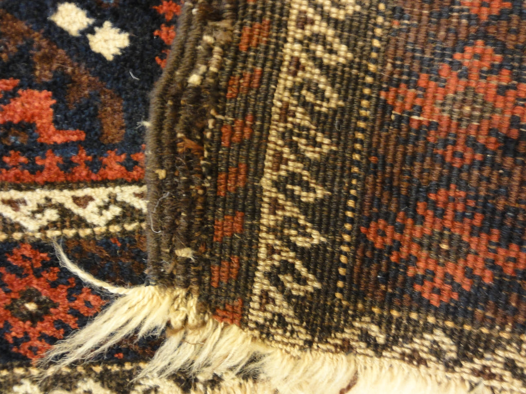 An antique and original burial Baluch dated rug. Dated on all four corners. Used as a casket covering. Sold by Santa Barbara Design Center.