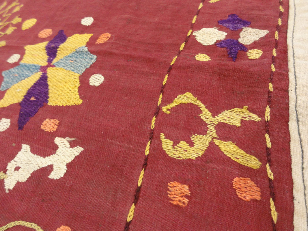 Antique Uzbek Turkestan Wool and Silk Suzani. A piece of wool and silk woven art sold by Santa Barbara Design Center Rugs and More in Santa Barbara CA.