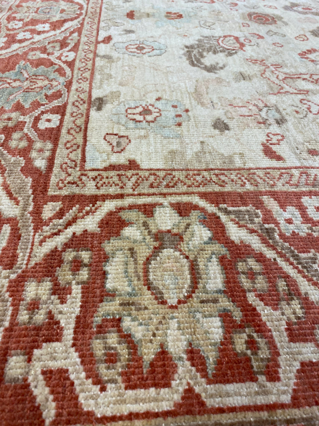 Close-up of Original Ziegler &amp; Co. Sultanabad rug, showcasing intricate floral patterns in red, beige, and soft blue tones.
