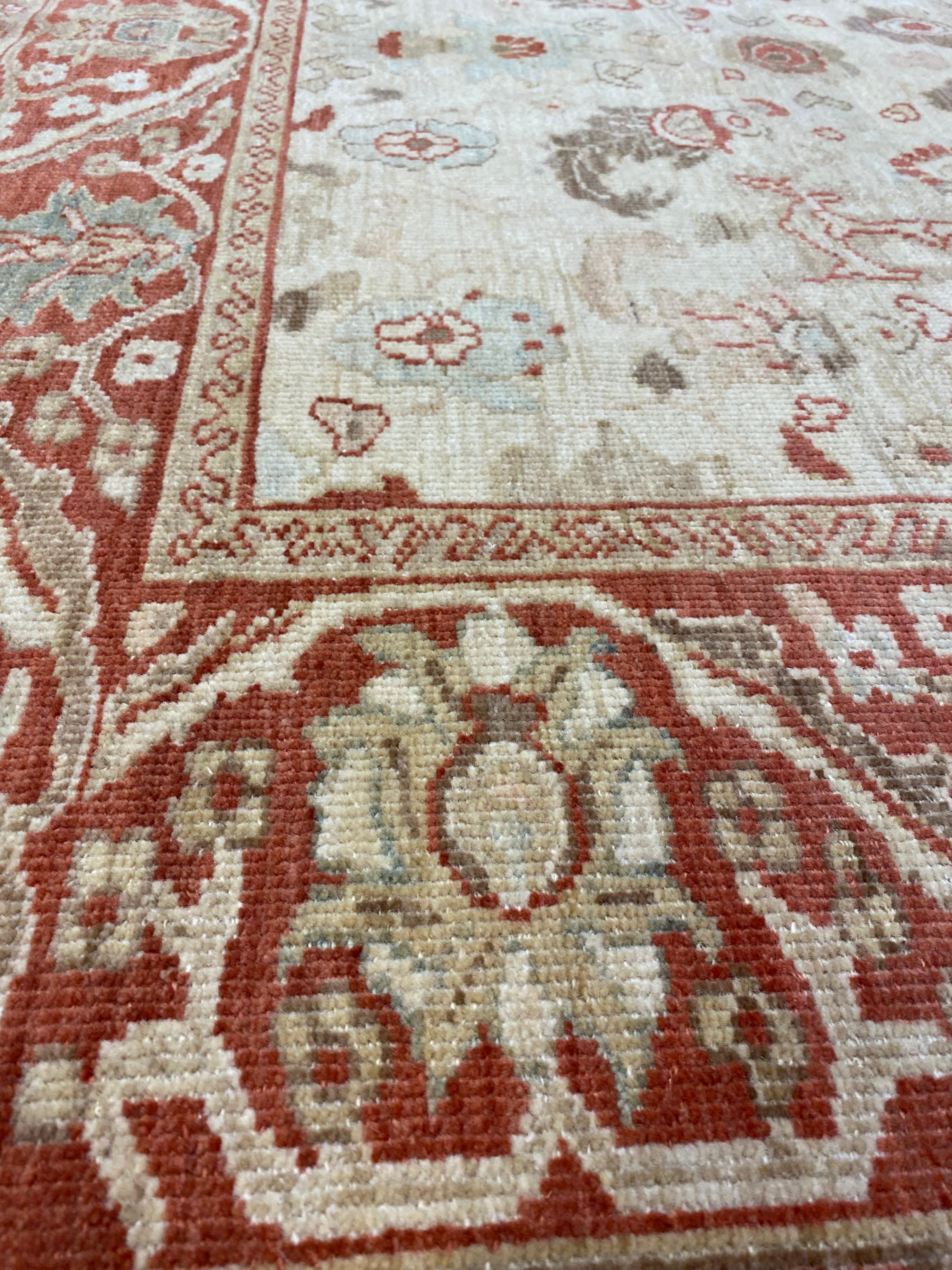 Close-up of Original Ziegler &amp; Co. Sultanabad rug, showcasing intricate floral patterns in red, beige, and soft blue tones.