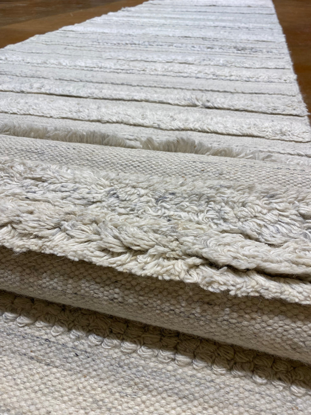 Close-up view of Ziegler & Co Montecito Vibe Runner, showcasing detailed texture and patterns in a light-colored fabric.