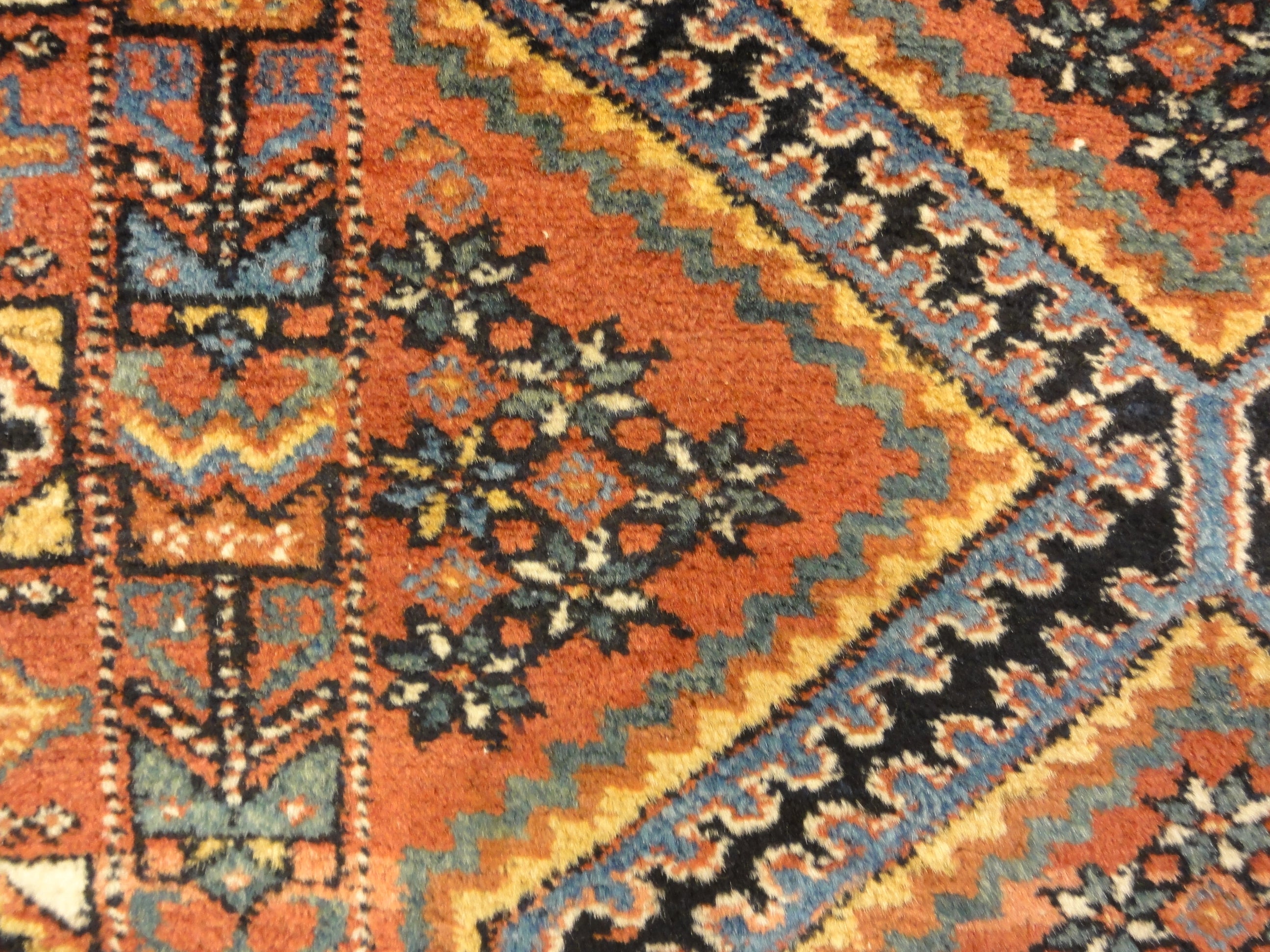 An antique Persian Afshar rug featuring a diamond pattern. A piece of genuine original woven carpet art sold by the Santa Barbara Design Center.