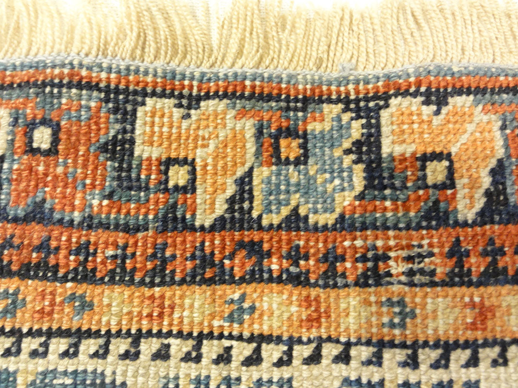 Antique Khamseh with Tribal Flowers. A piece of genuine woven carpet art sold at the Santa Barbara Design Center Rugs and More in Santa Barbara California.