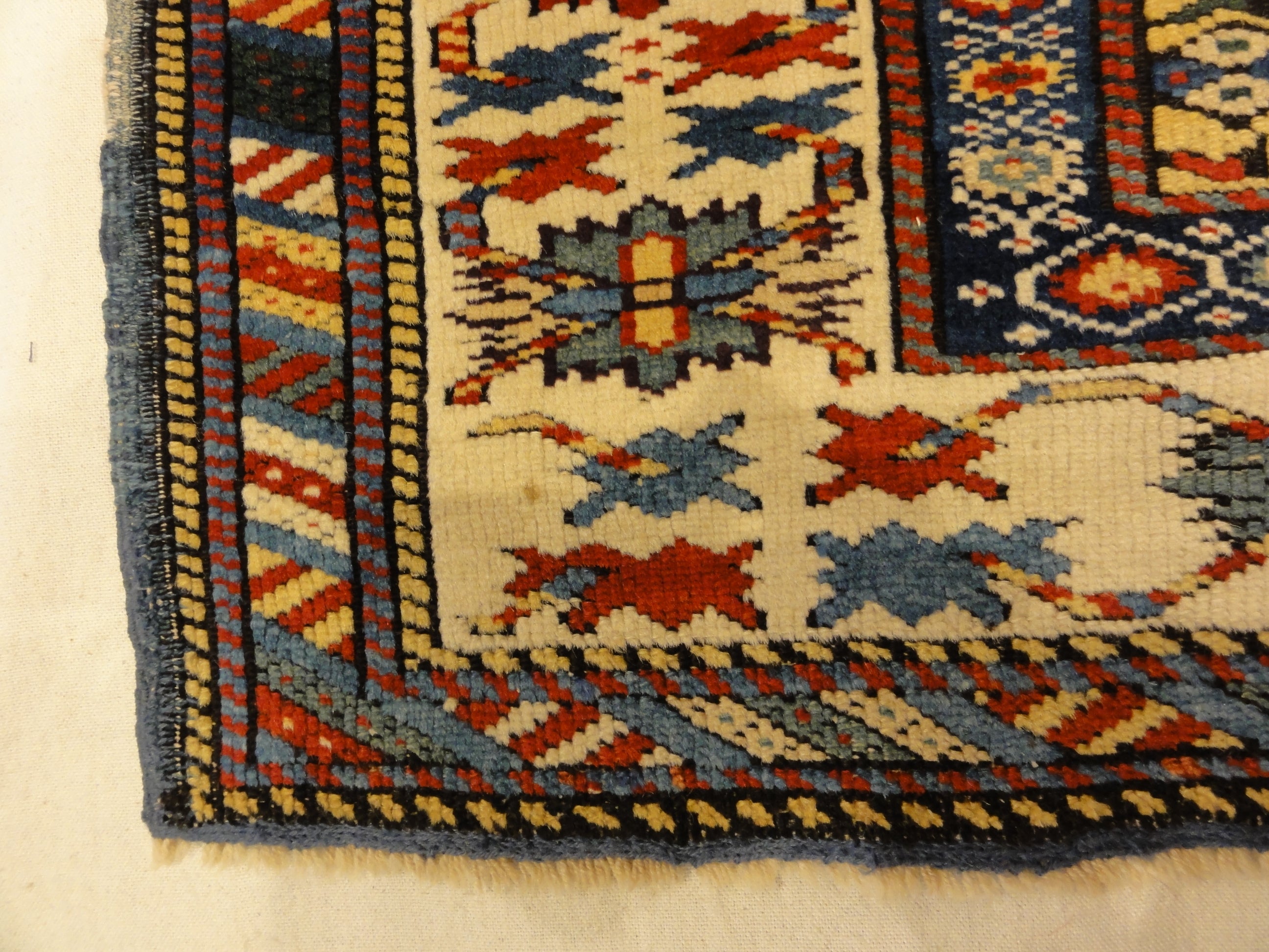 Antique Rare Gold Kuba Chichi Rug. A genuine authentic antique piece of carpet art sold by the Santa Barbara Design Center, Rugs and More.