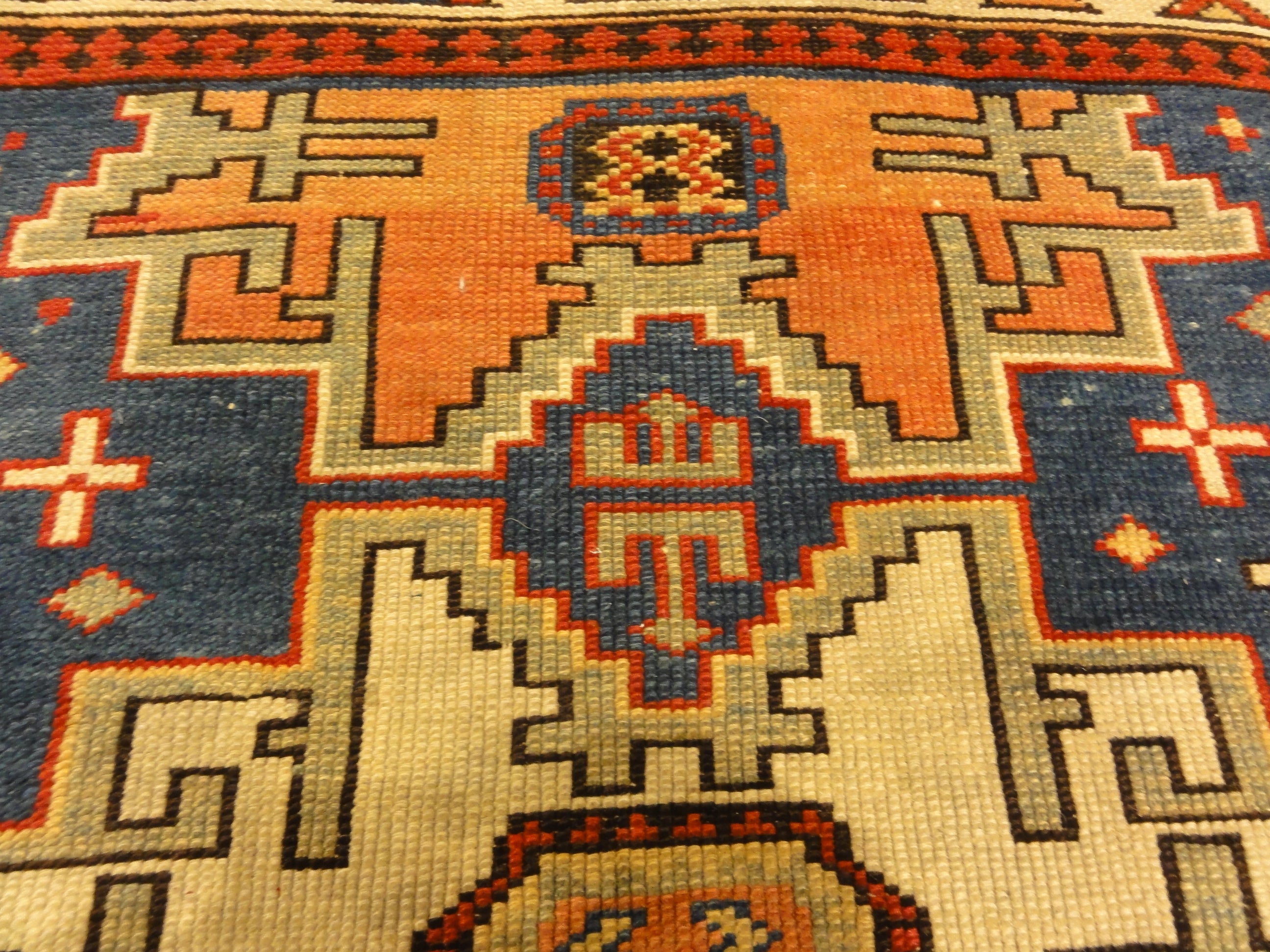 Rare Antique Leshgi Star Rug featuring Men Standing on Horses. A piece of genuine antique authentic woven carpet art sold by Santa Barbara Design Center.