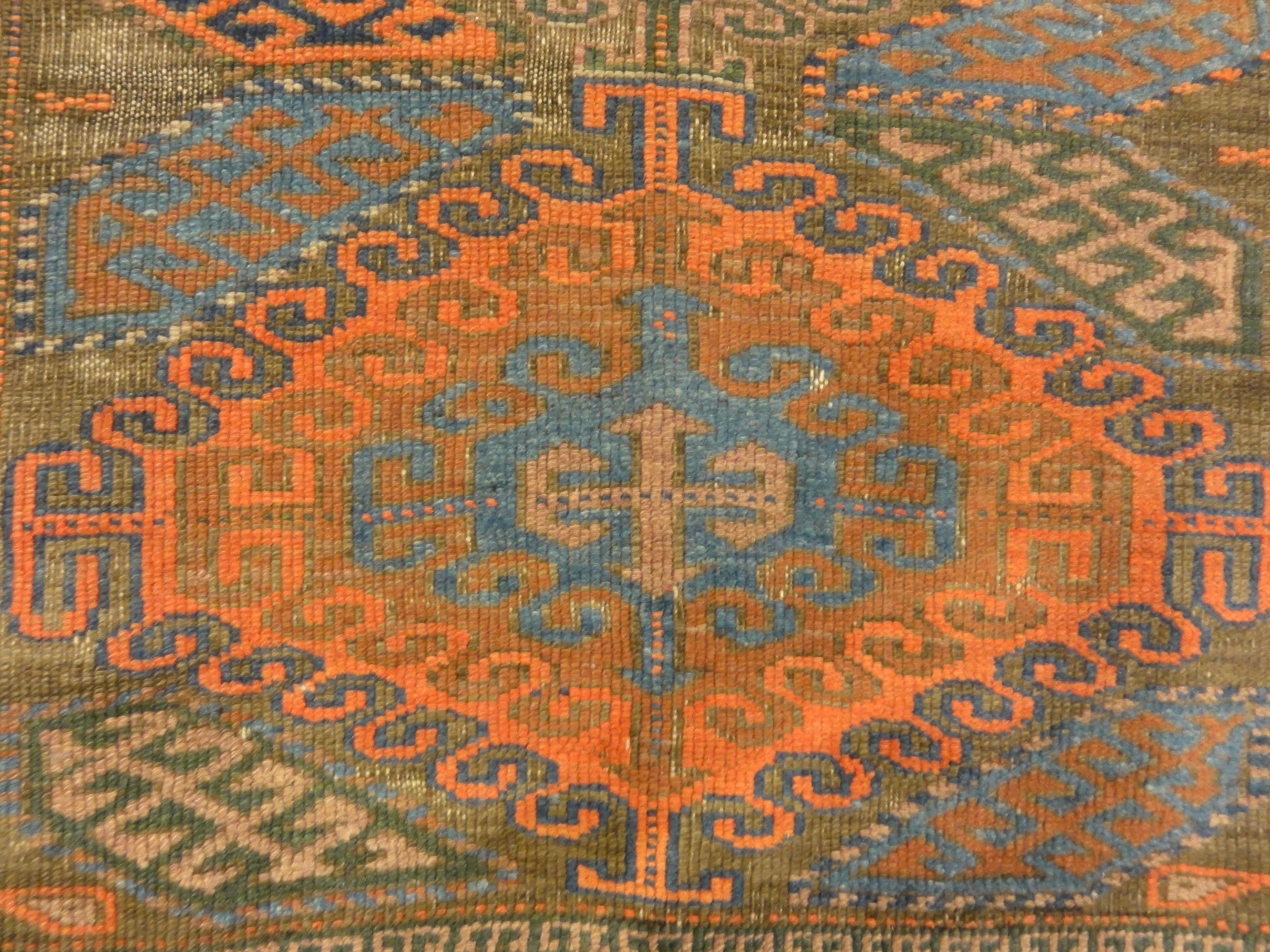 An antique original Mushwani Baluch rug handwoven in Afghanistan. A piece of genuine, authentic woven carpet art. Sold by Santa Barbara Design Center.