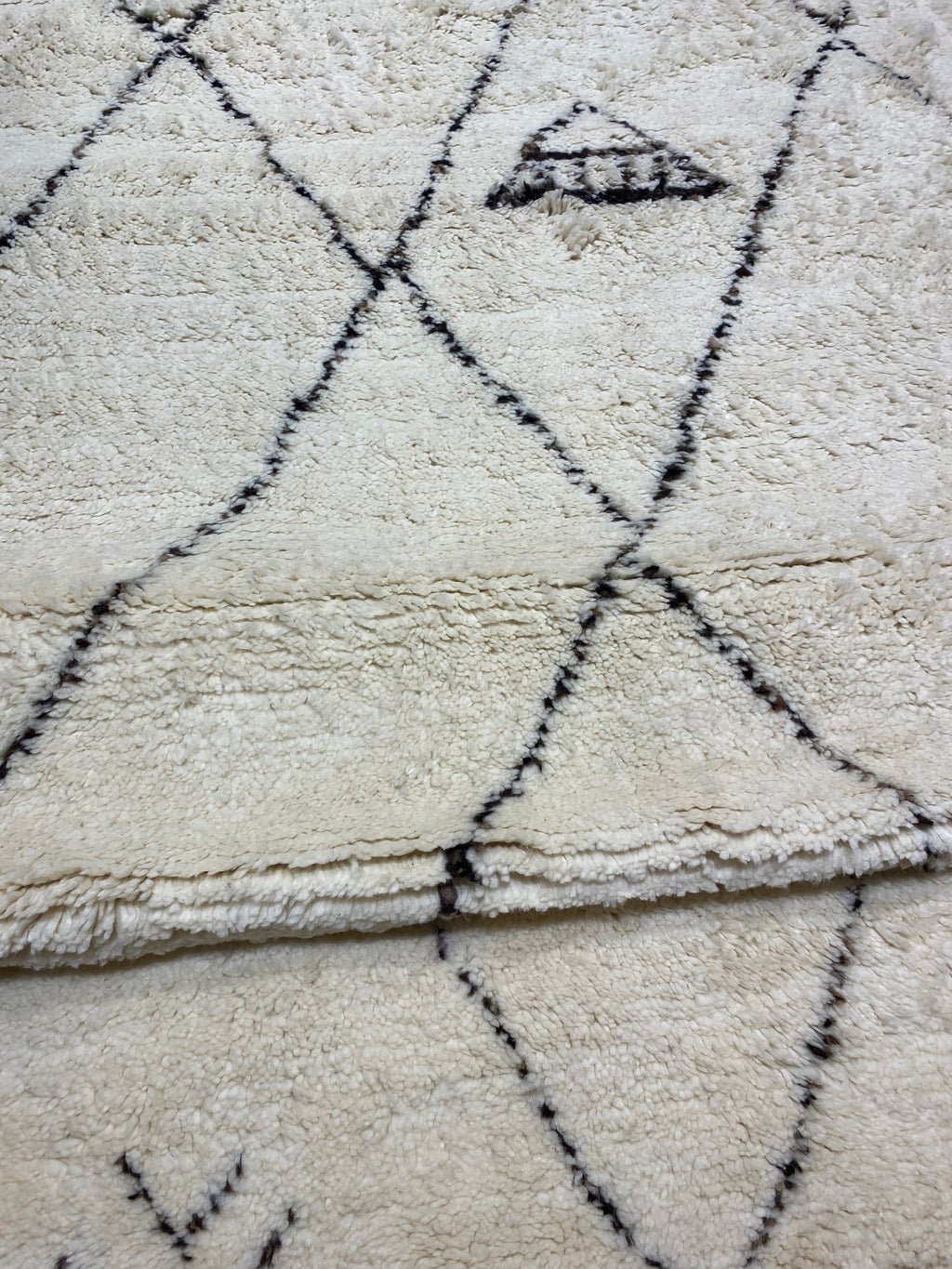 Close-up of the Santa Barbara Chic Moroccan rug, showing its soft texture and geometric diamond patterns.