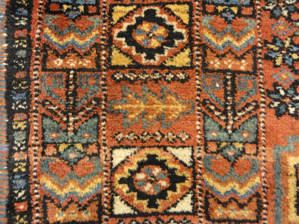 An antique Persian Afshar rug featuring a diamond pattern. A piece of genuine original woven carpet art sold by the Santa Barbara Design Center.