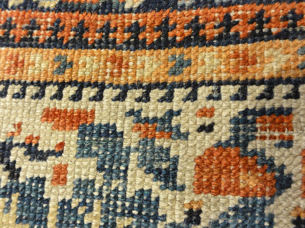 Antique Khamseh with Tribal Flowers. A piece of genuine woven carpet art sold at the Santa Barbara Design Center Rugs and More in Santa Barbara California.