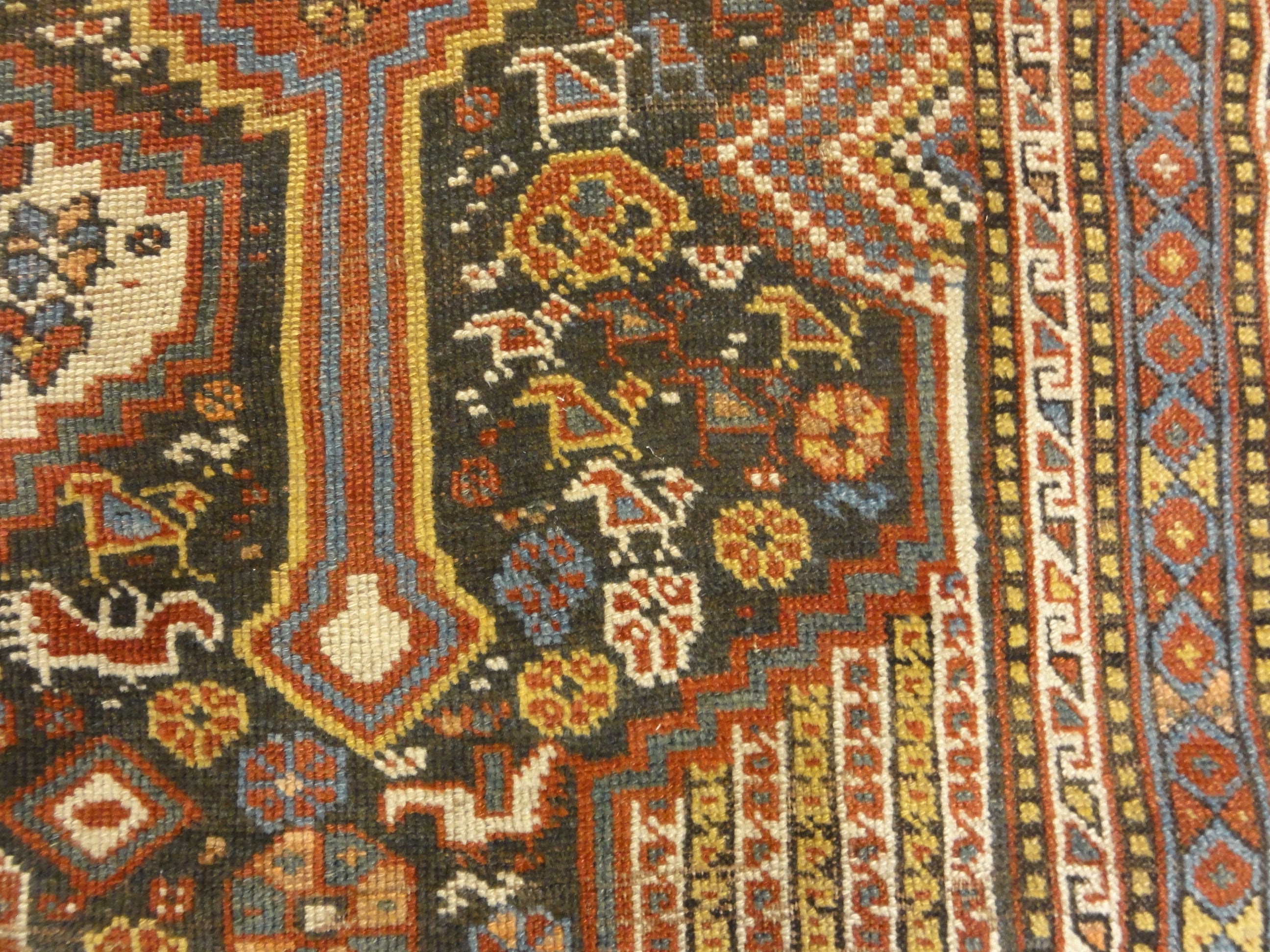 Antique Persian Khamseh Chicken Rug. A piece of genuine woven carpet art sold by Santa Barbara Design Center Rugs and More.