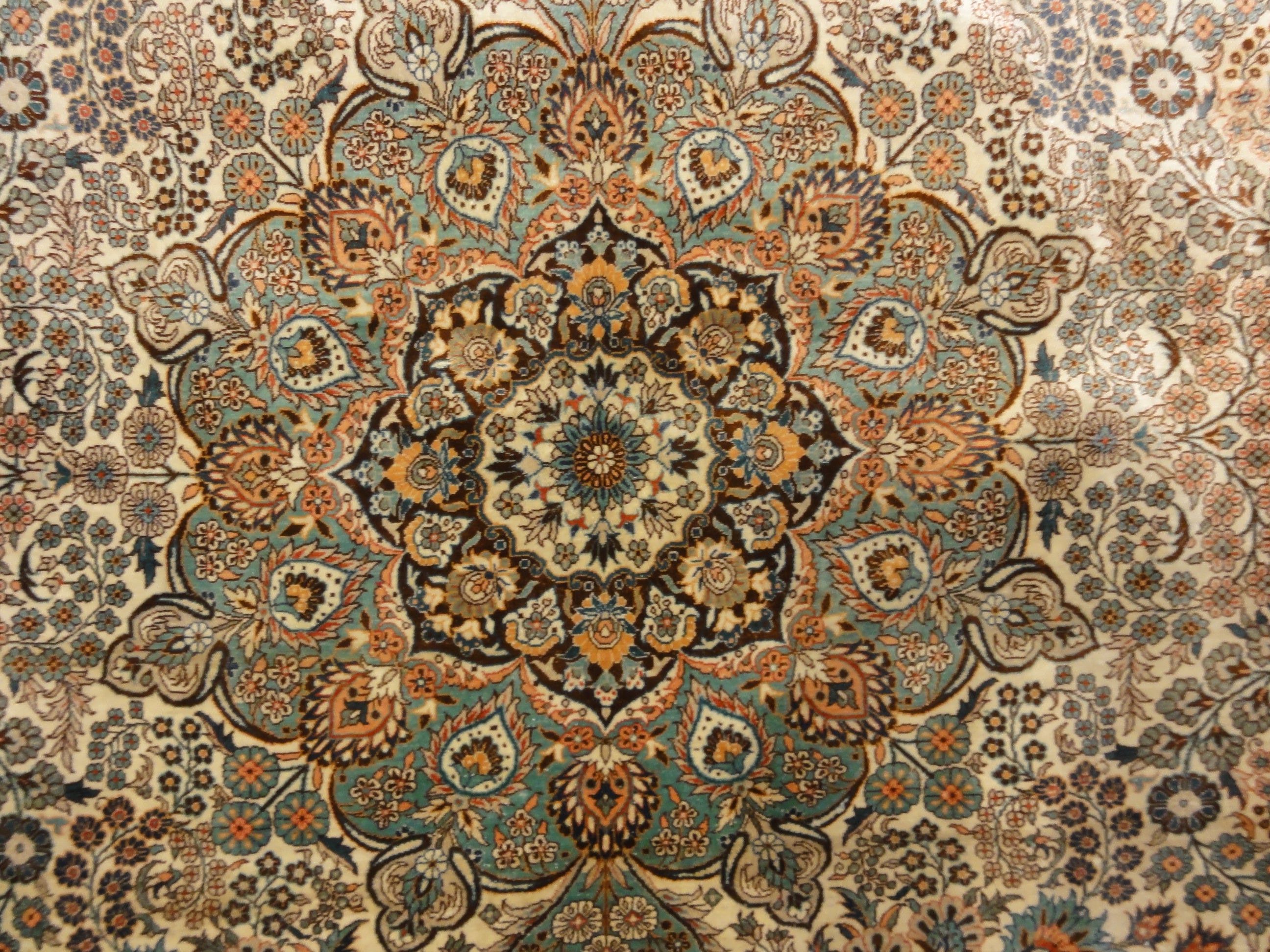 An antique finest silk rug featuring the garden of paradise with 1001 flowers. A piece of genuine woven carpet art sold at Santa Barbara Design Center.