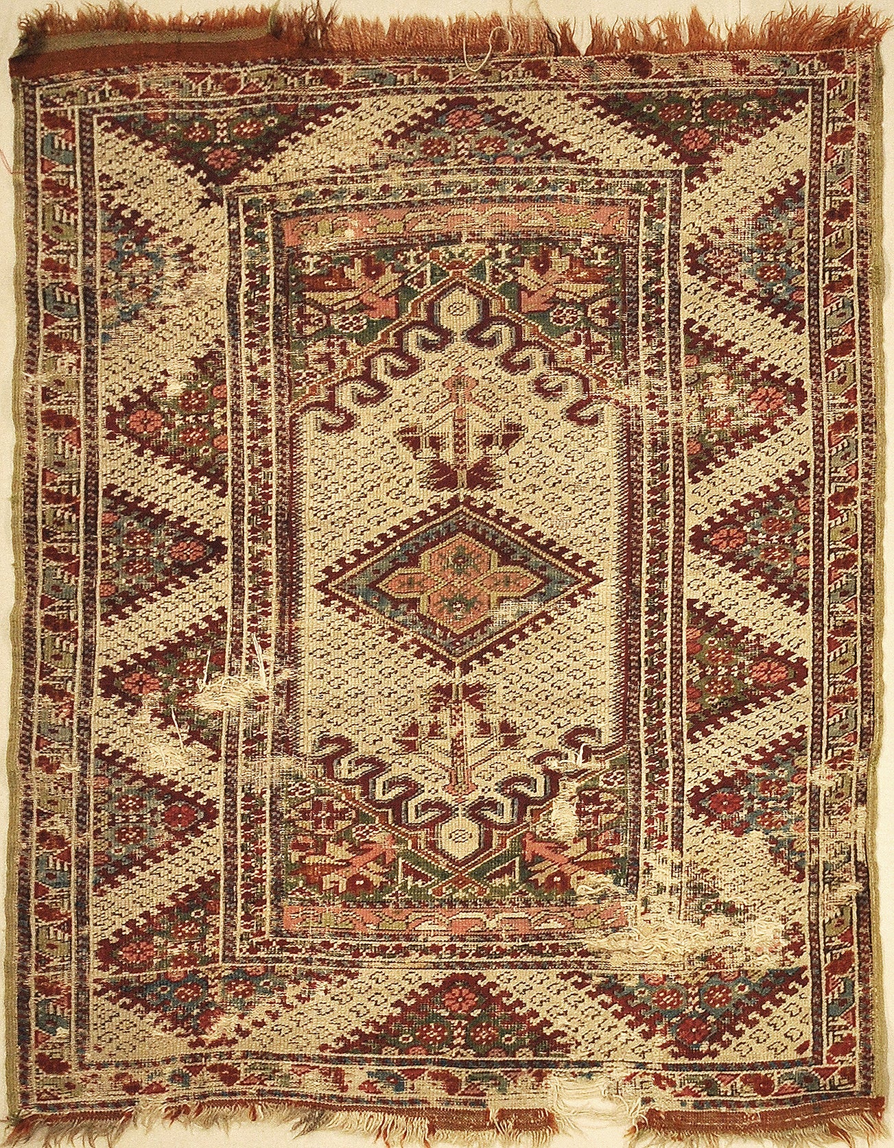 Antique Ghiordes Rug Circa 17th Century. A piece of genuine authentic antique woven carpet art sold by the Santa Barbara Design Center, Rugs and More.
