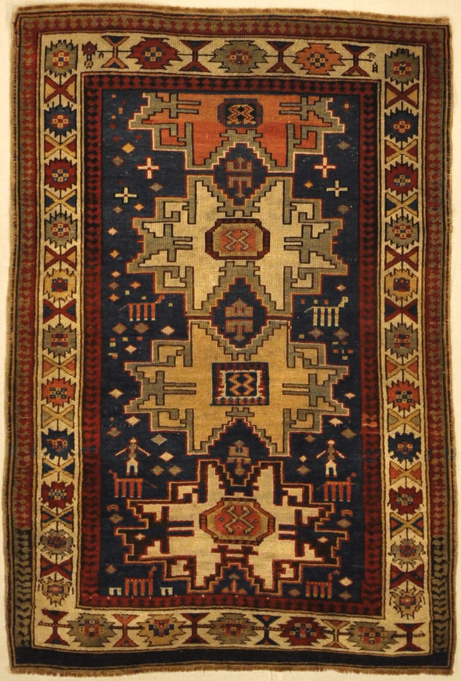 Rare Antique Leshgi Star Rug featuring Men Standing on Horses. A piece of genuine antique authentic woven carpet art sold by Santa Barbara Design Center.