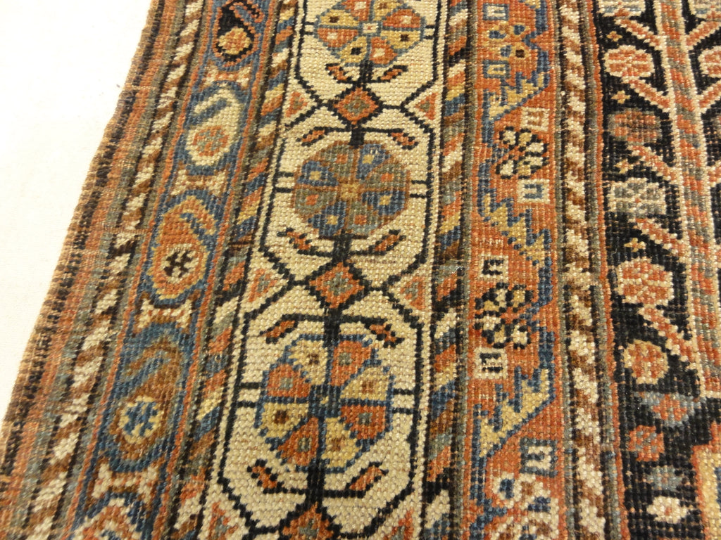 Antique Persian Qashqai featuring Tribal Flowers. A piece of genuine handwoven carpet art sold by Santa Barbara Design Center Rugs and More.
