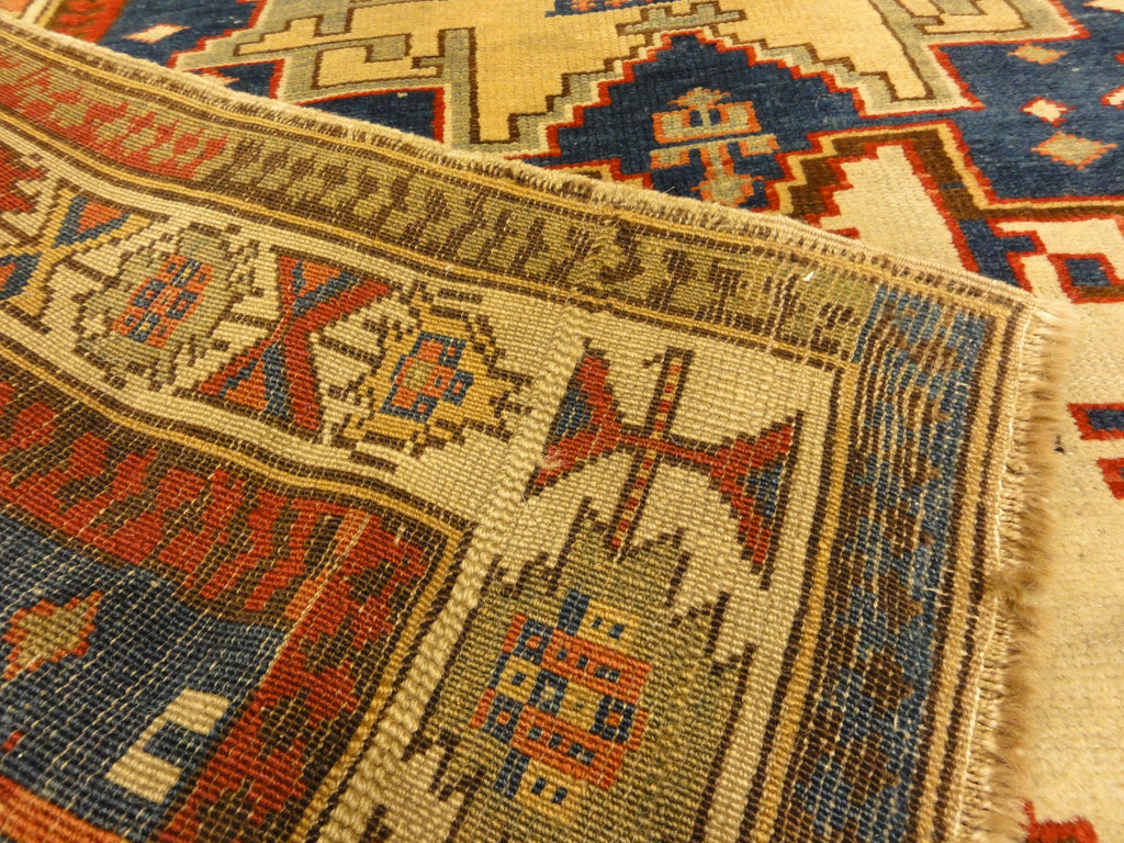 Rare Antique Leshgi Star Rug featuring Men Standing on Horses. A piece of genuine antique authentic woven carpet art sold by Santa Barbara Design Center.