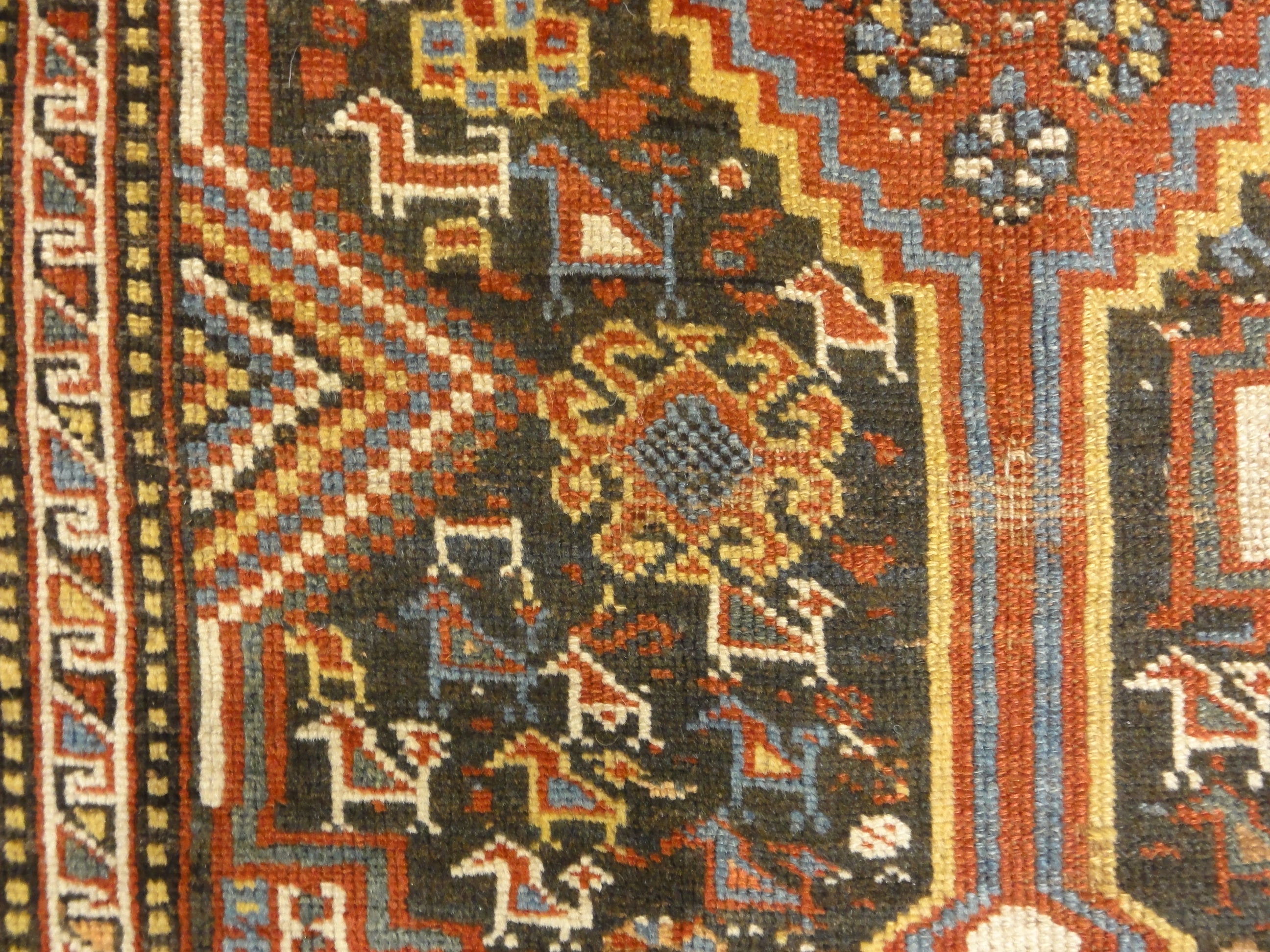 Antique Persian Khamseh Chicken Rug. A piece of genuine woven carpet art sold by Santa Barbara Design Center Rugs and More.