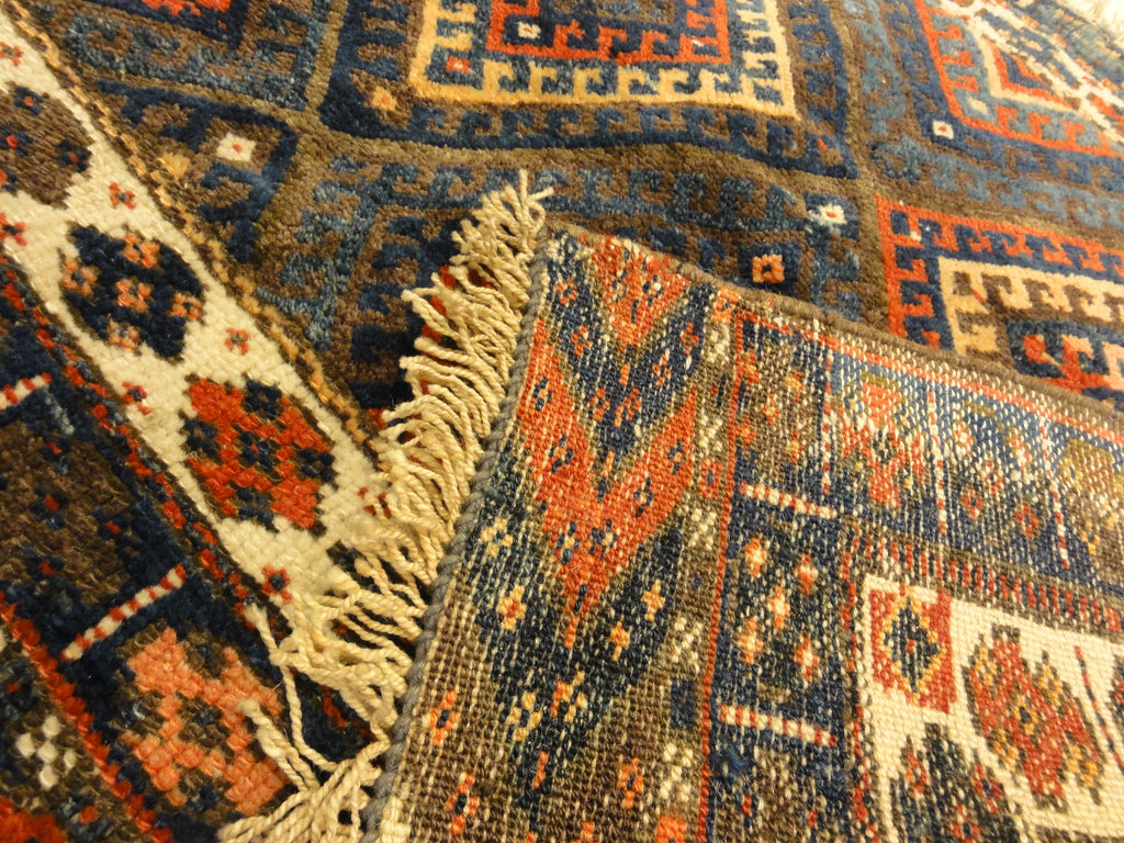 Kurdish Bagface Jaf Kurd. A genuine, antique piece of woven carpet art sold by Rugs & More in the Santa Barbara Design Center.