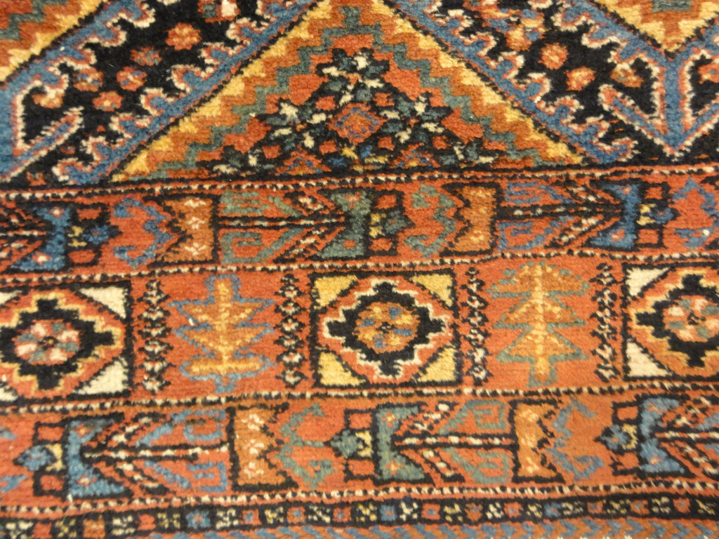 An antique Persian Afshar rug featuring a diamond pattern. A piece of genuine original woven carpet art sold by the Santa Barbara Design Center.