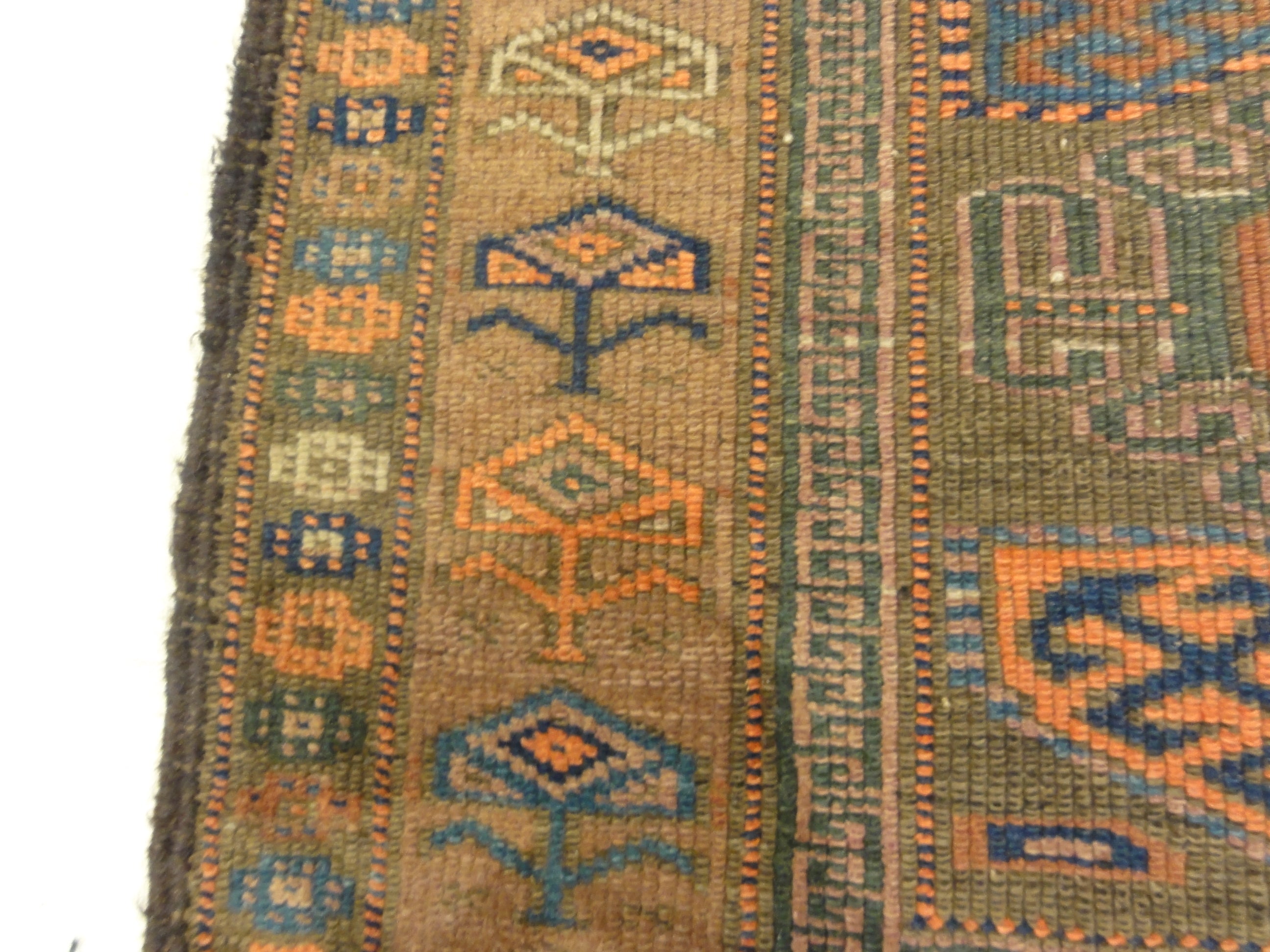 An antique original Mushwani Baluch rug handwoven in Afghanistan. A piece of genuine, authentic woven carpet art. Sold by Santa Barbara Design Center.