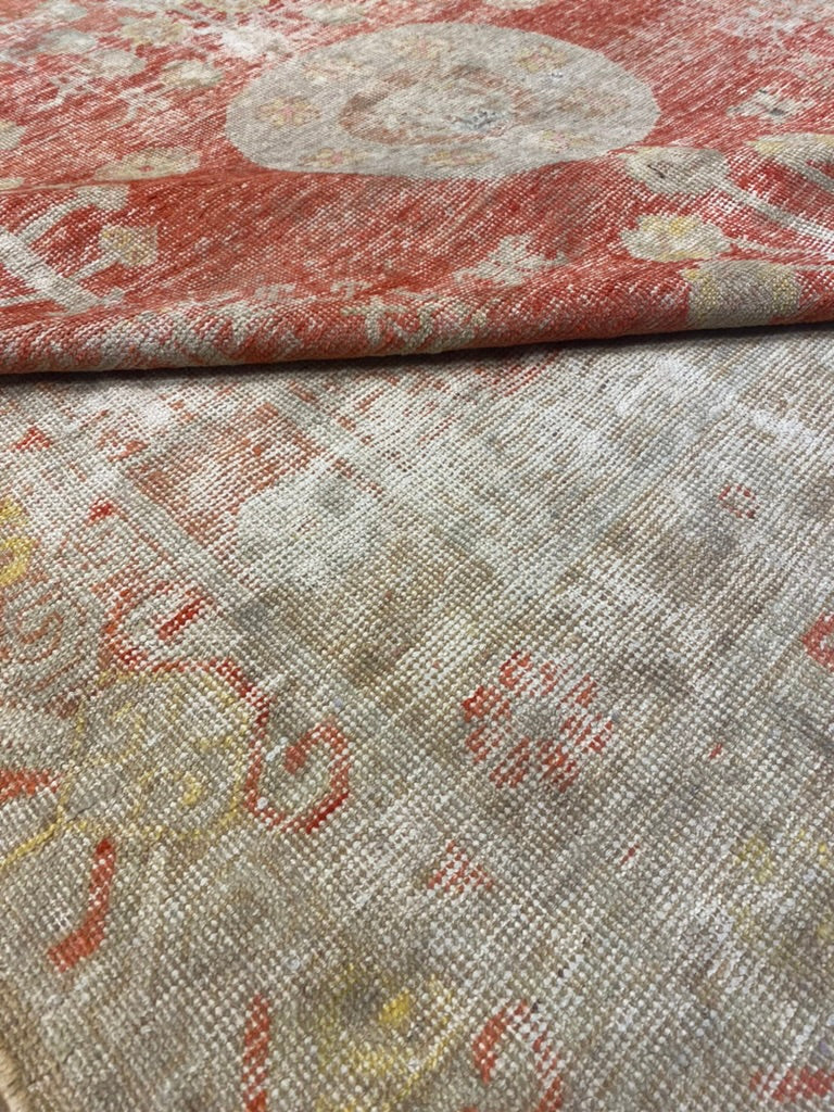 Folded to show texture, density, pattern, of Antique Khotan Rug